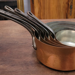 Set of five copper sauce pans with foundry stamp. They have been sourced from France and are in good original detailed condition.