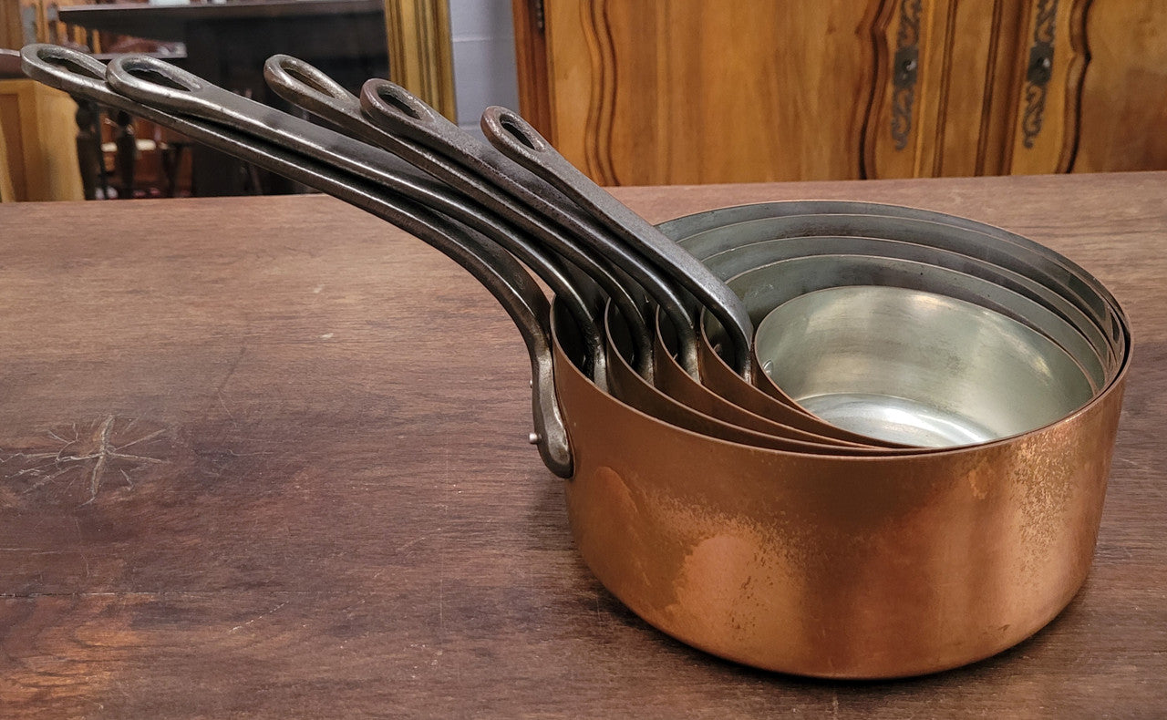 Set of five copper sauce pans with foundry stamp. They have been sourced from France and are in good original detailed condition.