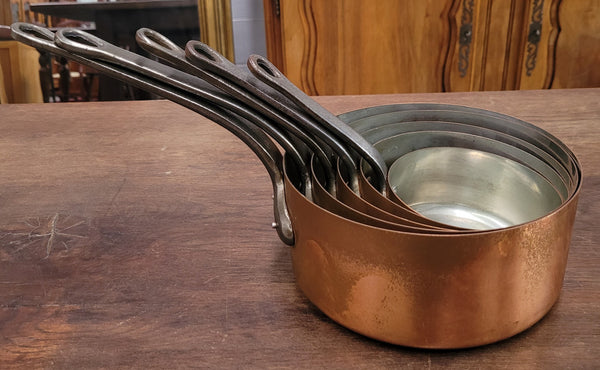Set of five copper sauce pans with foundry stamp. They have been sourced from France and are in good original detailed condition.