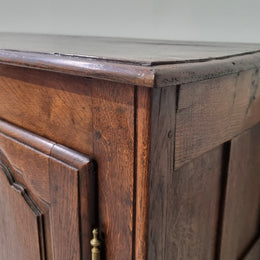 A charming French Oak early 18th Century two door sideboard. Plenty of storage space with two fixed shelves either side. It is in good original detailed condition for its age and comes with  a working key and working locks.