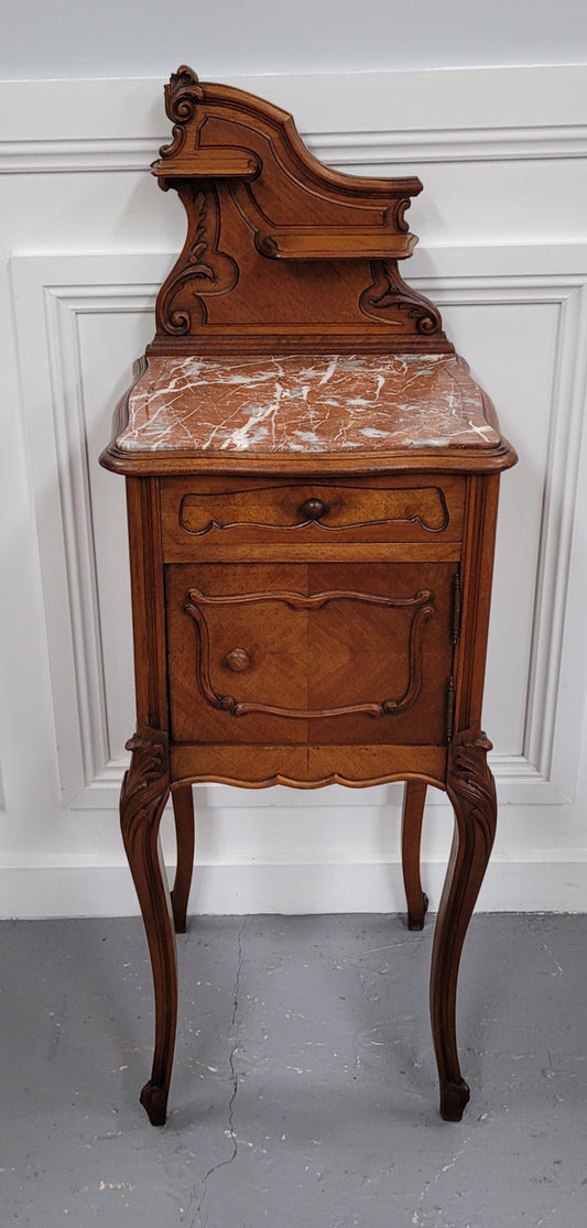 French Louis XV style Walnut single bedside cupboard with inset marble top. It has been sourced from France and is in good original detailed condition.