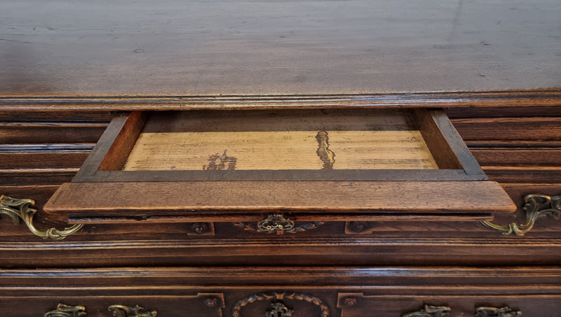 Early 19th century carved Oak three-drawer commode. Beautiful handles and has a small hidden drawer at the top. In good original detailed condition. Please note keys are not included.