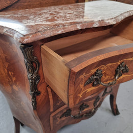 Antique French Louis XV style compact three drawer marble top commode with marquetry inlay and ormolu mounts. Sourced from France and in good original detailed condition.