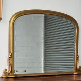 Antique arched over mantel gilt mirror. It has been sourced from France and is in good original detailed condition.