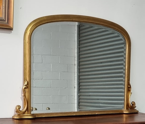 Antique arched over mantel gilt mirror. It has been sourced from France and is in good original detailed condition.