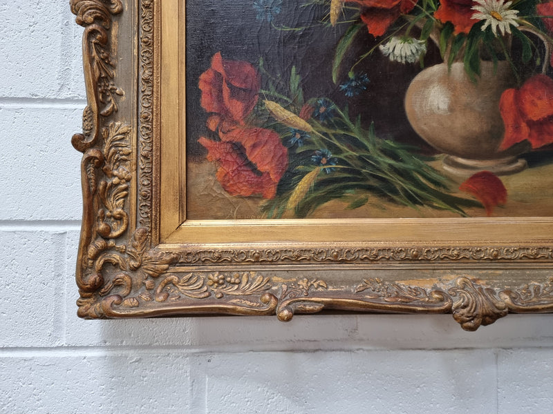 Lovely French signed floral oil on canvas of beautiful Poppies and Daisies in a ornate decorative frame. In good original condition.
