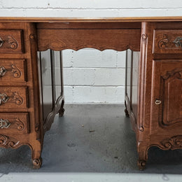 Beautifully carved french oak, faux partners desk with a lovely parquetry top and 6 drawers and 1 cupboard . In good original condition.