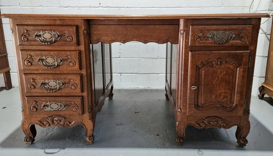 Beautifully carved french oak, faux partners desk with a lovely parquetry top and 6 drawers and 1 cupboard . In good original condition.