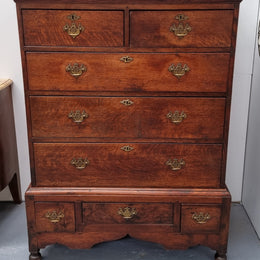Early 19th Century English Oak chest on stand. It has been sourced in France and has plenty of storage space with eight drawers. In good original detailed condition.