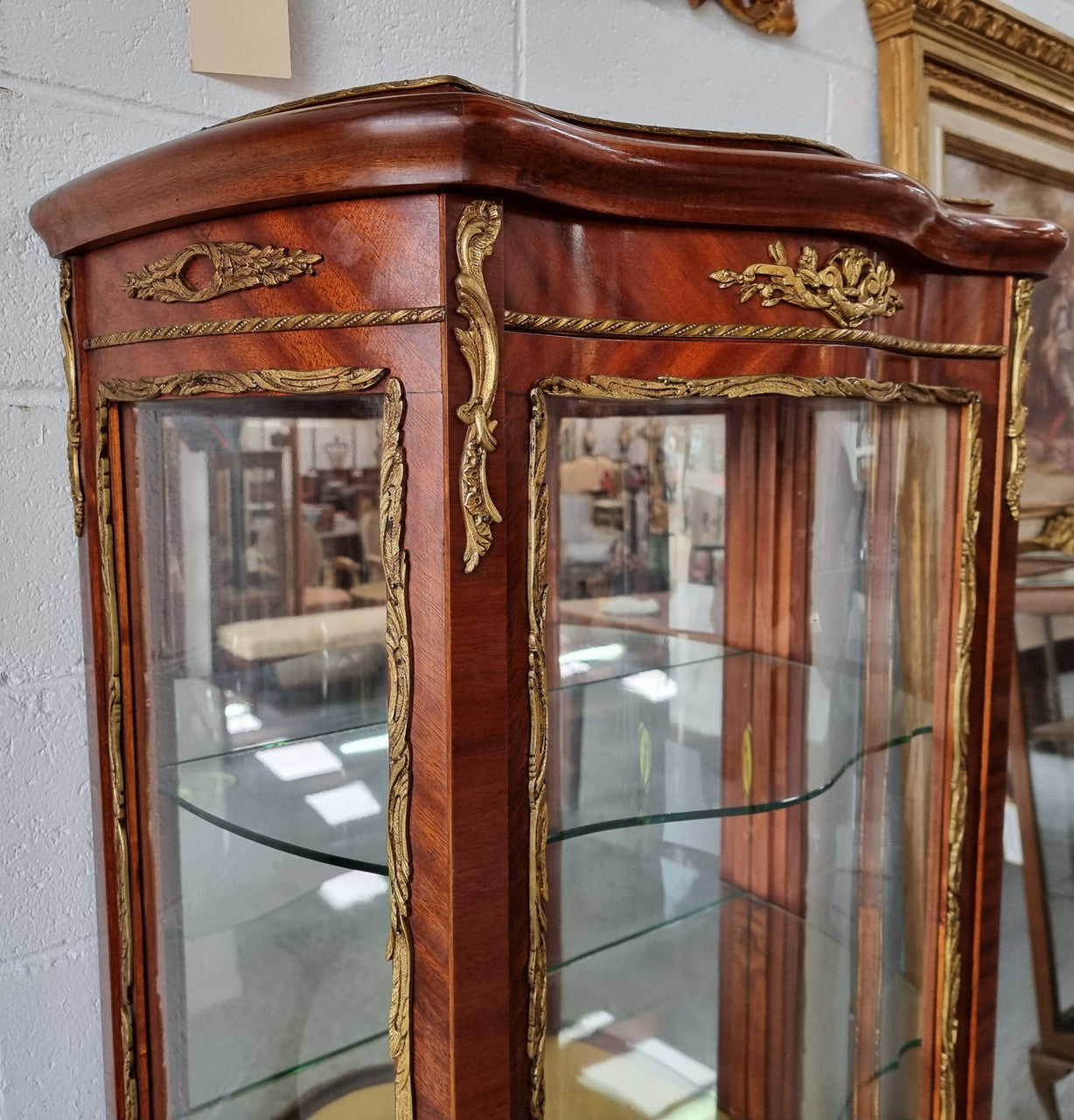 Lovely Vintage French Louis XVth style Vitrine. It has lovely gilt mount details and two glass shelves with room also for storage in good original condition.