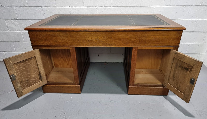 Amazing American Oak full partners leather top desk. Plenty of storage space with nine drawers on one side and two cupboards of the oppsite side. It is in good restored condition and has a new leather and gold tooled inset top.