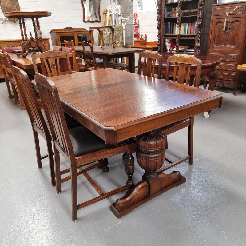 Tudor oak dining setting consisting of draw leaf extension table, 4 dining chairs and 2 carver chairs. Upholstery in excellent condition. Circa: 1930’s. The table, chair and carver chairs are in good original detailed condition.