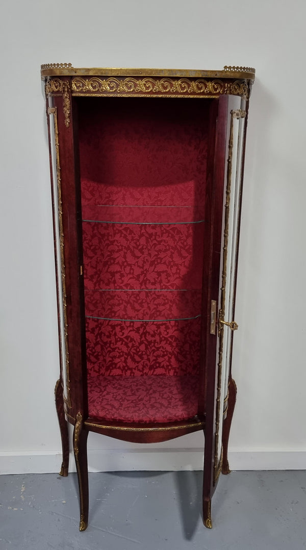 Louis XV style Walnut vitrine display cabinet with attractive ormolu mounts. Beautiful Maroon floral fabric backing with two glass shelves and cabriole legs with decorative ormolu mounts. In good original detailed condition.