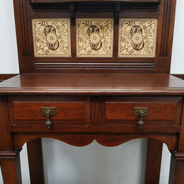 Beautiful English Edwardian tiled back hall stand, with nine brass hooks, two small drawers and retaining it's original mirror and showing signs of age. In good original condition.