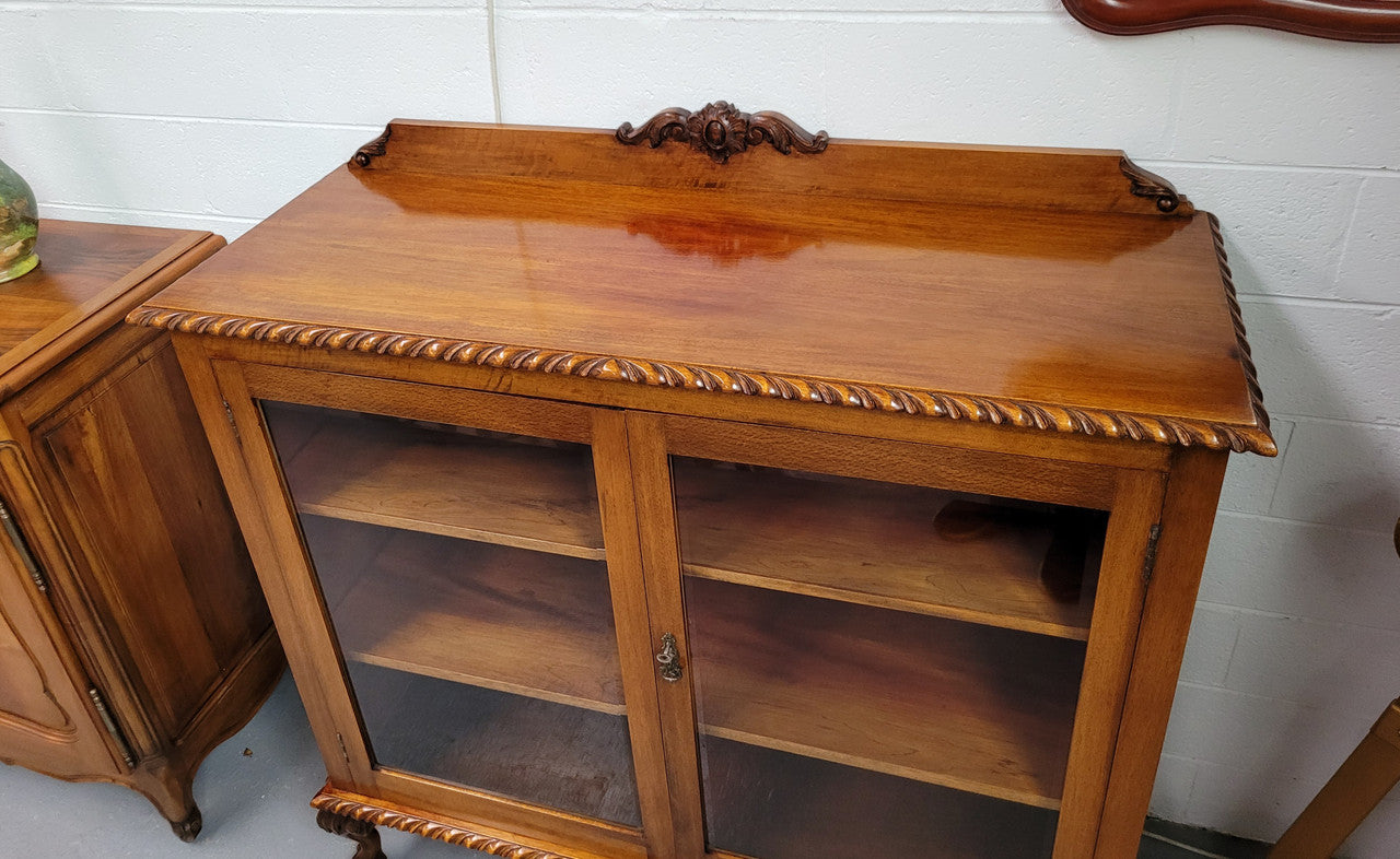 Chippendale style Mahogany two door bookcase. It has bevelled glass doors and two adjustable shelves. It has been sourced locally and is in good original detailed condition.