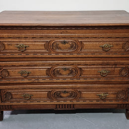 Early 19th Century French Oak chest of three drawers. It has beautiful handles and carvings. It is in good original detailed condition.