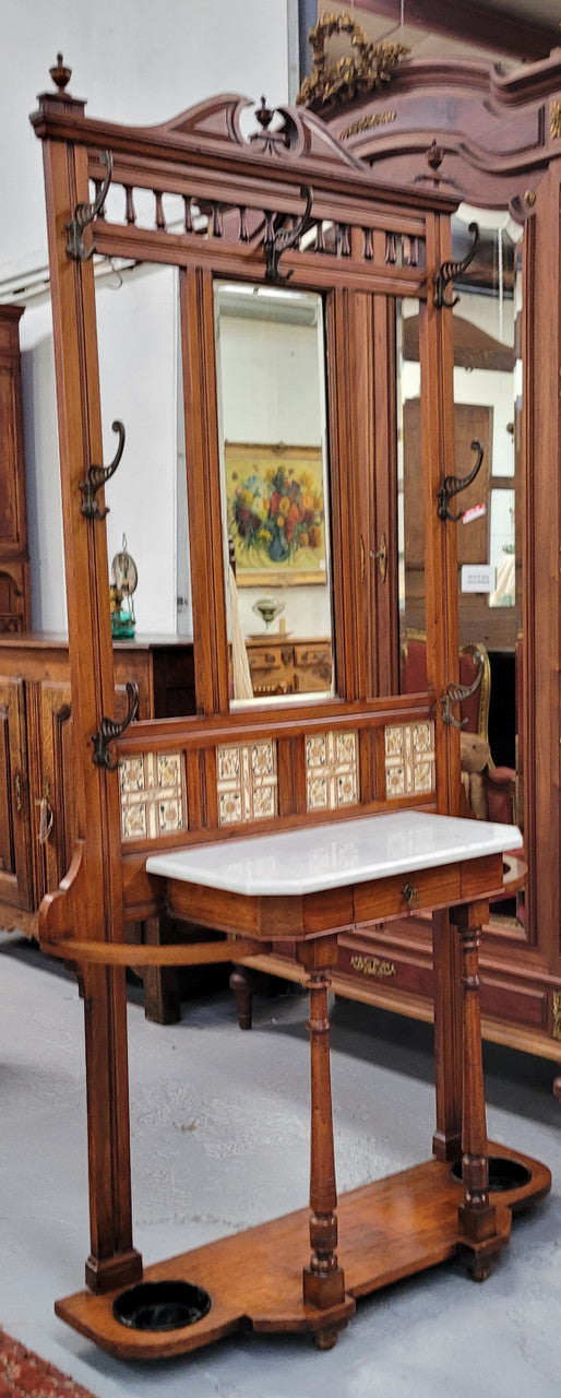 Late Victorian Arts and Crafts style marble top hall stand. Features three attractive tiles, original hooks and single drawer. In good original condition.