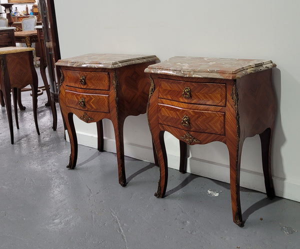 Pair of Louis XV commode style two drawer bedsides with beautiful marble tops and decorative mounts. They are a rare size and are in good, detailed condition.