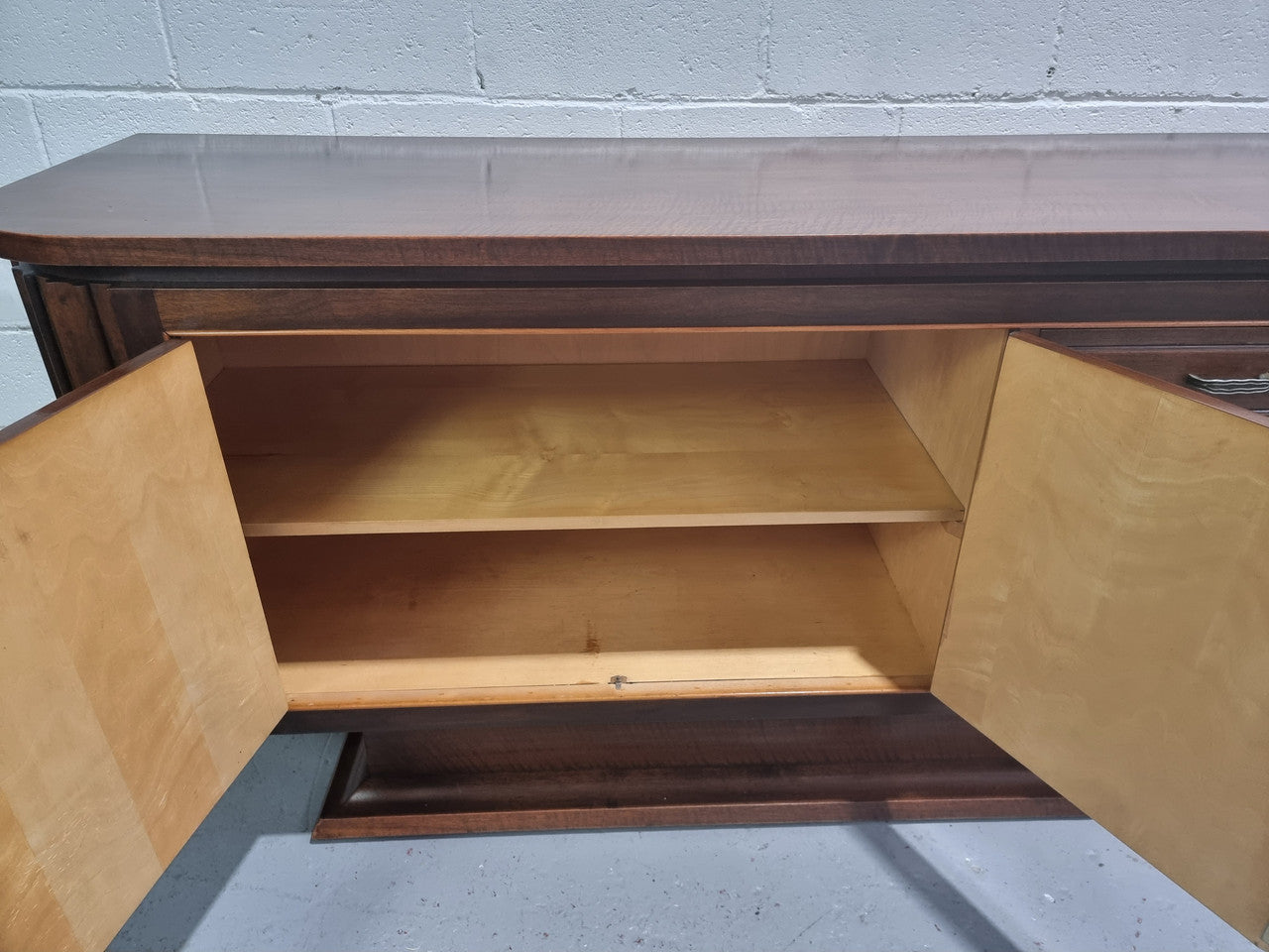 Amazing French Walnut Art deco four door buffet. The doors either side open to a fixed shelf and plenty of added storage with four drawers. In good original detailed condition.
