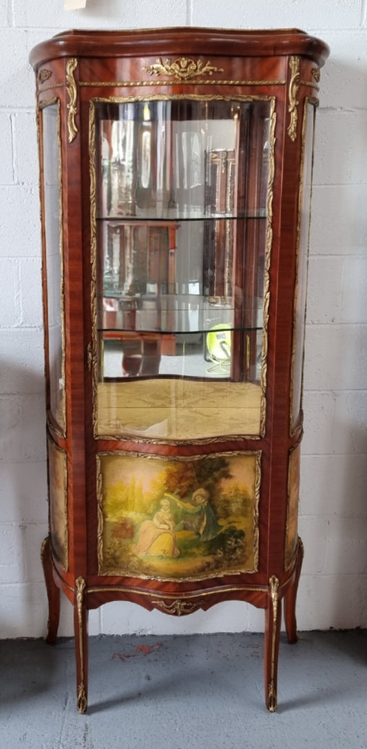 Lovely Vintage French Louis XVth style Vitrine. It has lovely gilt mount details and two glass shelves with room also for storage in good original condition.