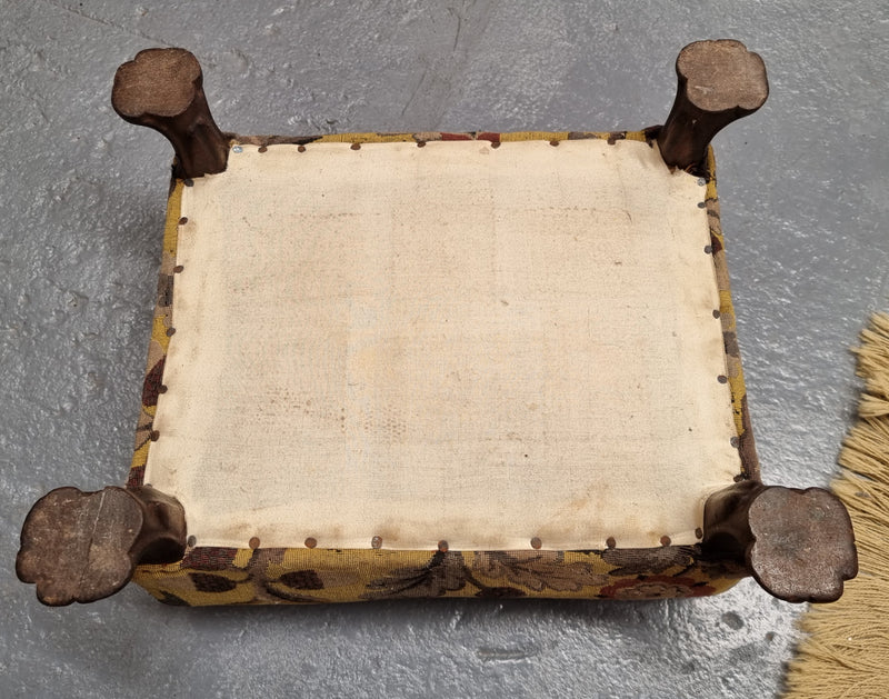 Lovely Upholstered Georgian footstool with feet. It has been sourced locally and is in good original condition.