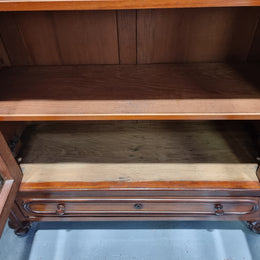 Antique Mahogany two door Biedermeier style bookcase with four fully adjustable shelves and a drawer at the bottom. The two wooden finials at the top are easily removed for a different look of desired. In good original detailed condition.