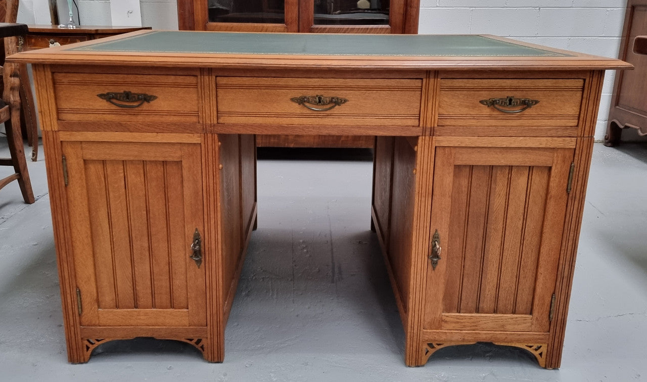 French Oak Art Deco full partners desk with leather top. Plenty of storage with both sides having three drawers at the top and two cupboards on both sides, one side has a filing section with three internal drawers and the other has a shelf on one side with three internal drawers as well. In good original detailed condition.