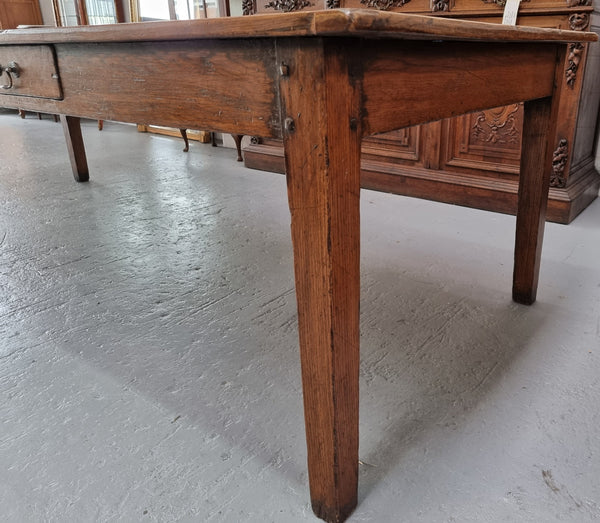 Amazing 19th Century French Oak Farmhouse style dining table with three drawers. It is made from three large planks of wood which is very hard to find. It is also very wide with a width of 105.5 cm. It is in good original detailed condition.