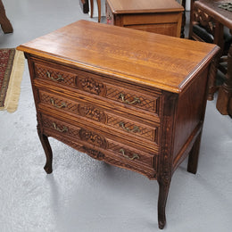Rustic Louis XV style Oak petite three drawer chest featuring attractive carvings. It has been sourced locally and it is in good original detailed condition.