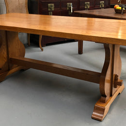 A French Style Oak stretcher base table with amazing wood grain. Can comfortable sit 6-8 people and is in original detailed condition.