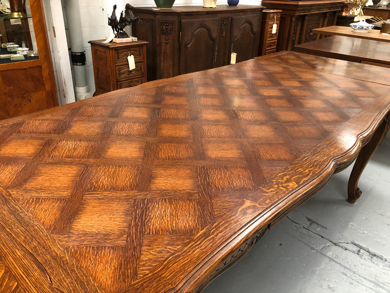 High quality French Oak Louis XV Style, beautifully carved extension table. It has an amazing parquetry top and when fully extended measures to 3 meters long. In very good original detailed condition.