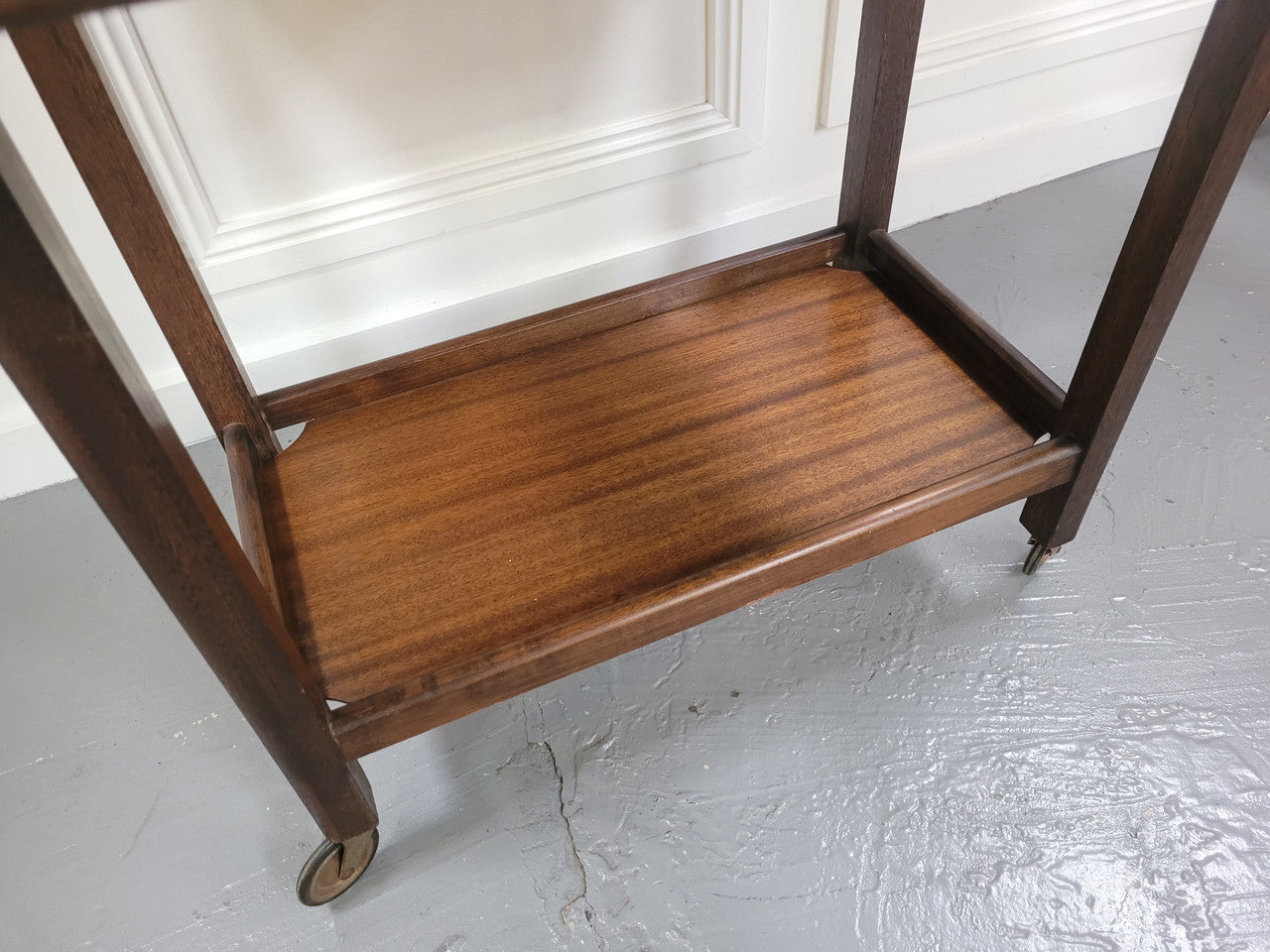 Oak drop leaf auto trolley on wheels. Both sides open up to make a larger table. It is in good original detailed condition.