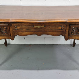 Attractive large Louis XV style Oak faux partners desk. Nicely carved details with three large functioning drawers, and three faux drawers at the back. In good original detailed condition.
