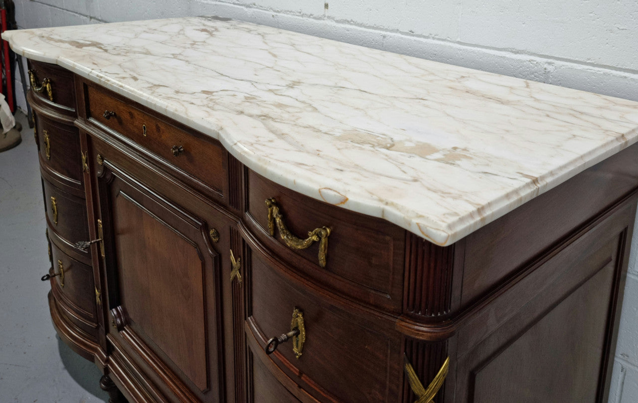 Fabulous French Walnut Louis XVI style cupboard, with a lovely marble top and nine drawers. There is also a cupboard and beautiful ormolu mounts. It is in good original detailed condition.