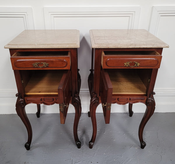 Pair of French Antiloopque Louis XV style Walnut and marble top bedsides. They have lovely carvings along with a drawer and cupboard space. They are in good original detailed condition and have been sourced from France