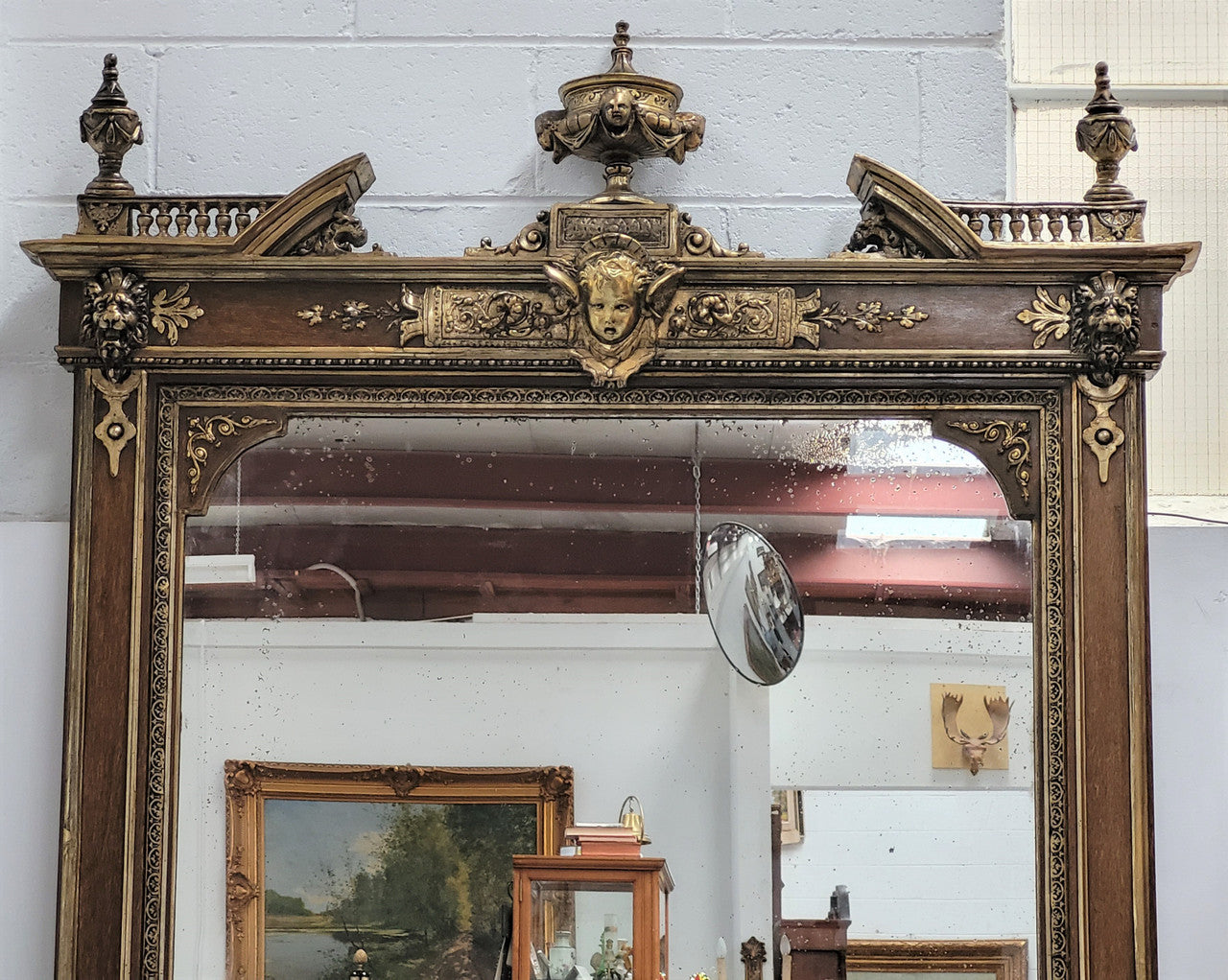 Early 19th Century French gilt and simulated wood mantel mirror. It still contains its original glass which contains loads of character. It is in very good detailed condition and has had minor restorations.