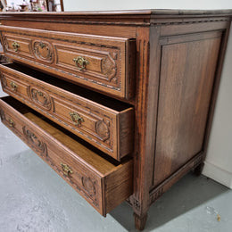 Early 19th Century French Oak chest of three drawers. It has beautiful handles and carvings. It is in good original detailed condition.