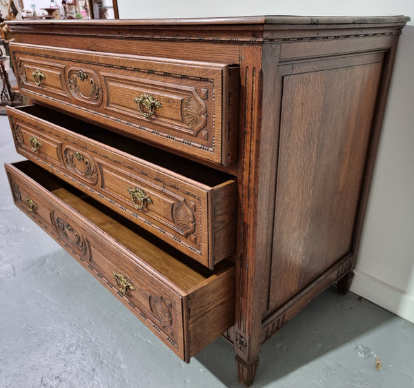 Early 19th Century French Oak chest of three drawers. It has beautiful handles and carvings. It is in good original detailed condition.