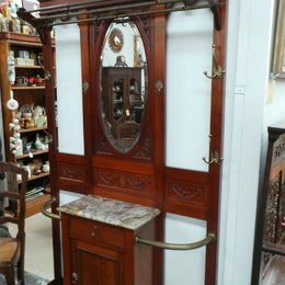French mahogany hall stand with a marble top drawer. It has beautiful large brass hooks and fittings. It is in very good original detailed condition.