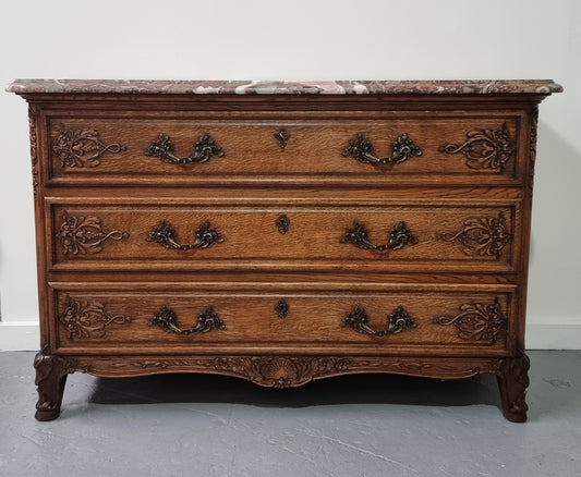 French Louis XV style three drawer Oak marble top commode. In good original detailed condition.
