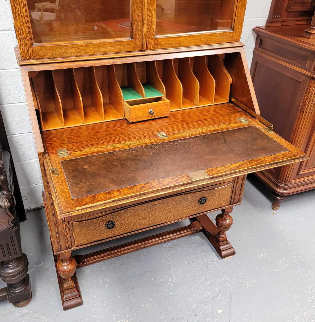 Stunning Art Deco secretary desk bookcase with heaps of storage space. It has a leathered writing area, bookcase with three adjustable shelves and three large drawers at the bottom. It has been sourced locally and in good original detailed condition.