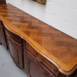 French Oak Louis XV style three drawer three door parquetry top sideboard. It has been sourced from France and is in good original detailed condition.