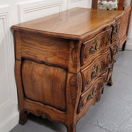 French Antique Louis XIV style Oak wooden top commode. It has a stunning serpentine bombe shape front along with amazing handles and carvings. It comes with three beautiful keys as pictured and comes with working locks. It has been sourced from France and in good original detailed condition.