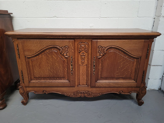 French Oak Louis XV Style two door nicely carved cabinet which would make an ideal TV cabinet. There are two doors for all your storage needs and is a very solid piece. In good original detailed condition.