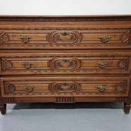 Early 19th Century French Oak chest of three drawers. It has beautiful handles and carvings. It is in good original detailed condition.