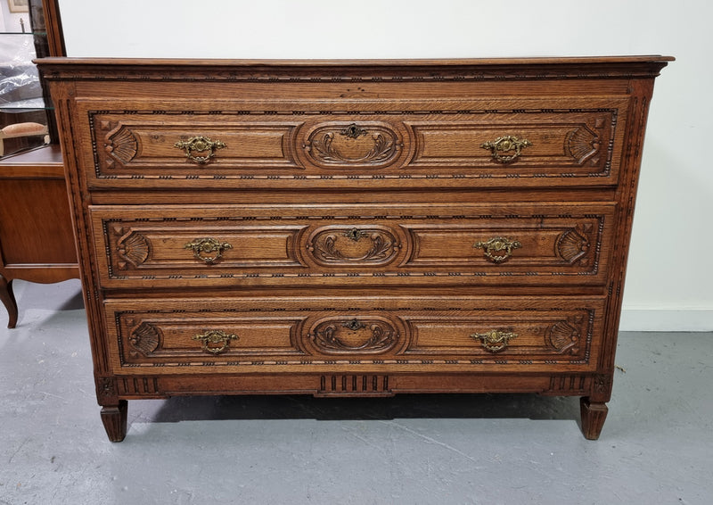 Early 19th Century French Oak chest of three drawers. It has beautiful handles and carvings. It is in good original detailed condition.