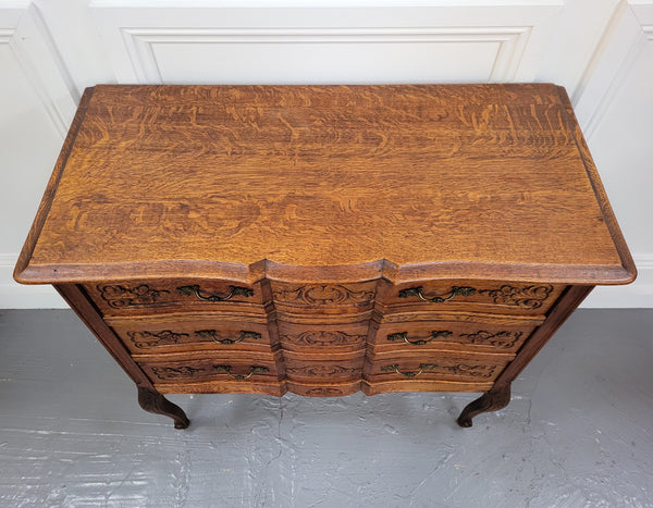 Vintage French dark Oak Louis XV style chest of three drawers. It has beautiful cabriole legs, elegant brass handles and decorative carving throughout. It is in good original detailed condition and has been sourced from France.