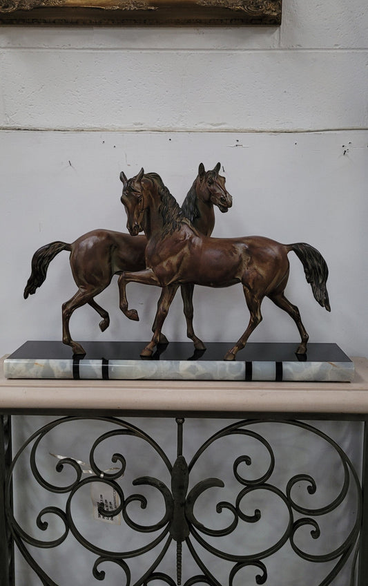Art Deco patinated bronze French spelter horses on a stunning marble base. It is in good original detailed condition.