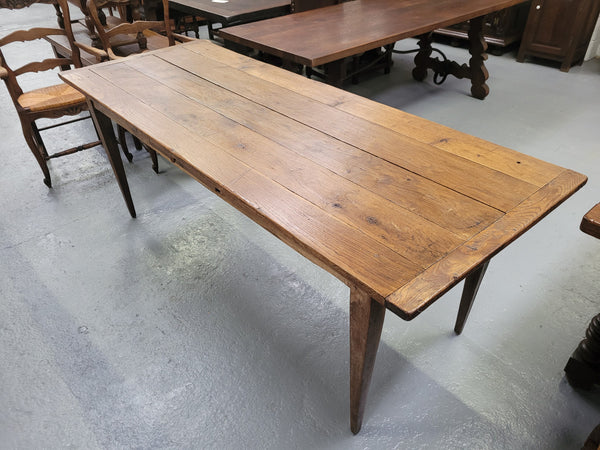 Provincial 19th Century French Oak rustic farmhouse table with tapered leg and single drawer. It has been sourced from France and is in good original detailed condition. 