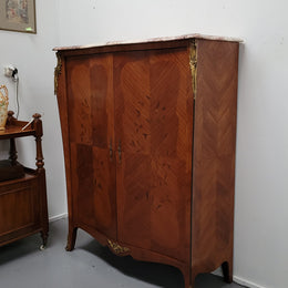 French Louis 15th style Kingwood marquetry inlaid two door cupboard with a beautiful marble top. It has three adjustable shelves and decorative ormolu trim. It has been sourced from France and is in good original detailed condition.